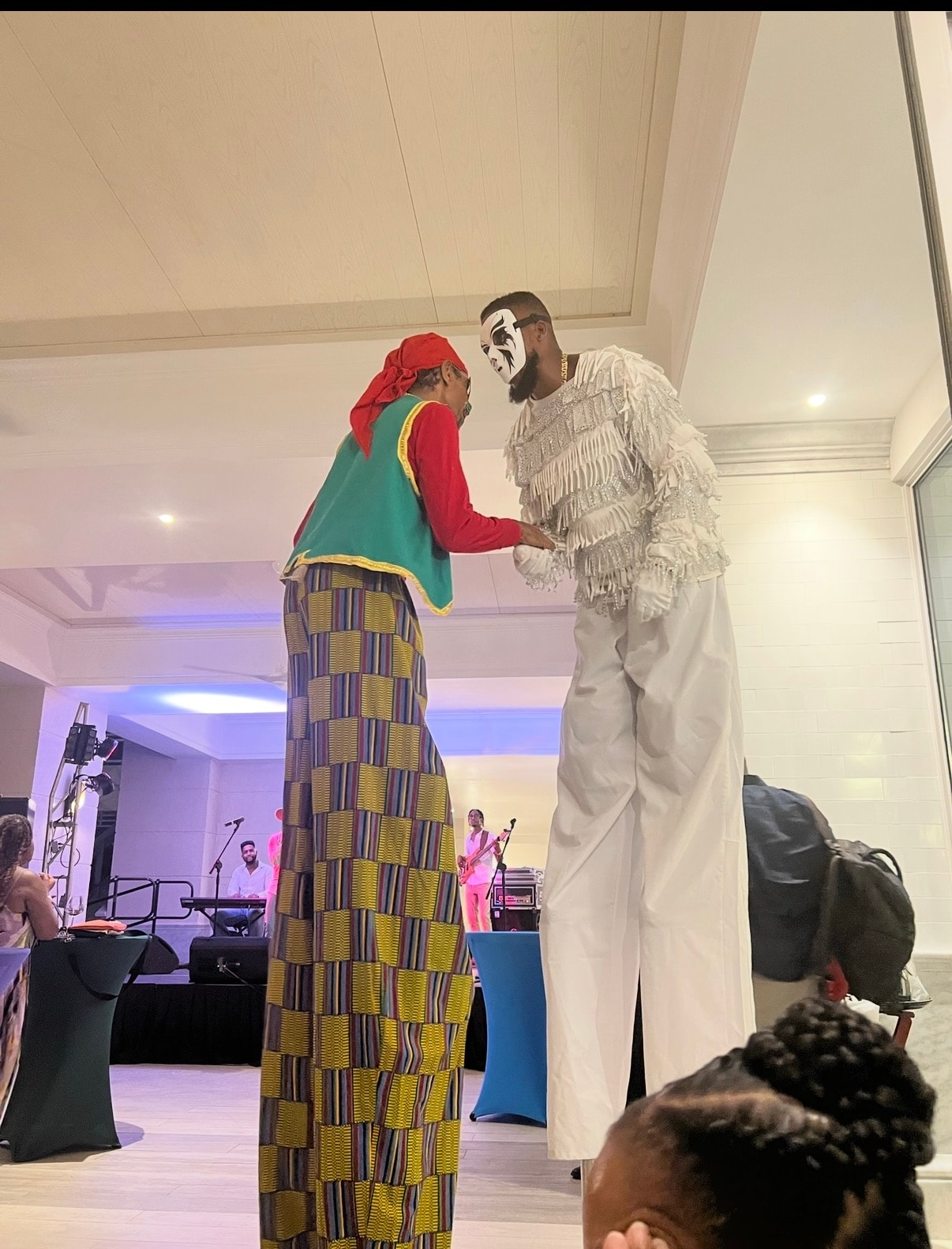 Stilt performers at a vibrant evening event